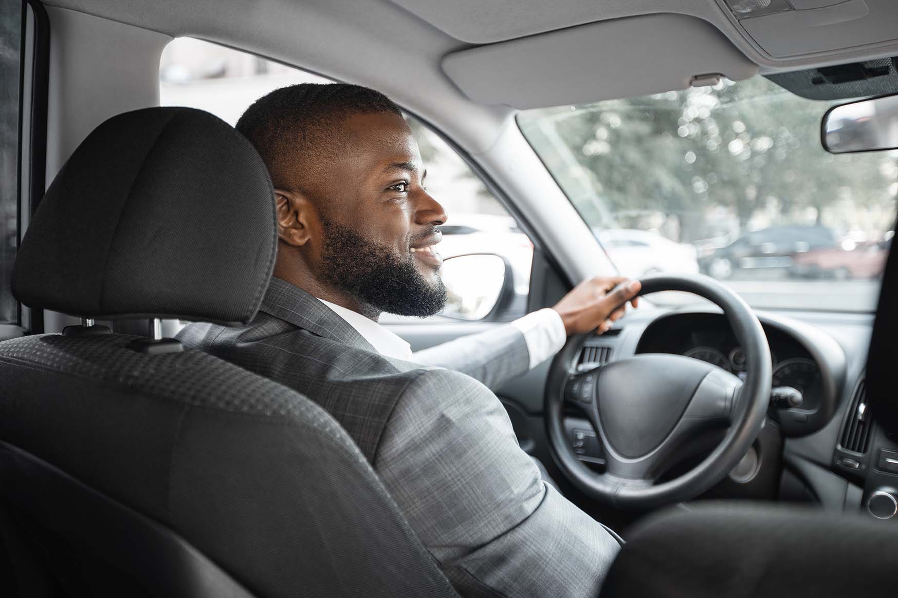man inside of a vehicle he just got from a vehicle subscriptions